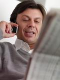 adult man reading stock exchange listings at home