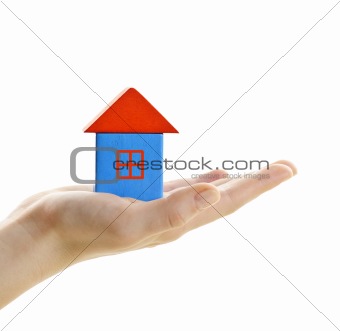 Wooden block house on hand