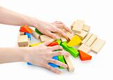 Hands with wooden block toys