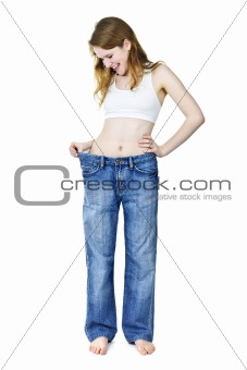 Happy girl in jeans after losing weight