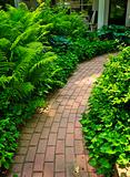 Brick path in landscaped garden