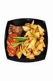 Grilled meat and  fried  potatoes  on a plate