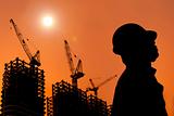 The Silhouette of Construction workers with sunset