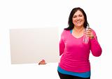 Attractive Middle Aged Hispanic Woman In Workout Clothes with Water Bottle and Blank White Sign Against a White Background.
