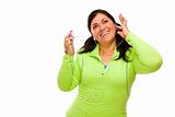 Attractive Middle Aged Hispanic Woman In Workout Clothes with Music Player and Headphones Against a White Background.