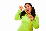 Attractive Middle Aged Hispanic Woman In Workout Clothes Showing off Her Tape Measure Against a White Background.
