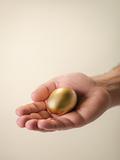Man showing golden eggs, symbol of money saving