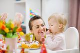 Mother spending fun time with baby on birthday party