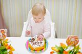 Baby eating birthday cake