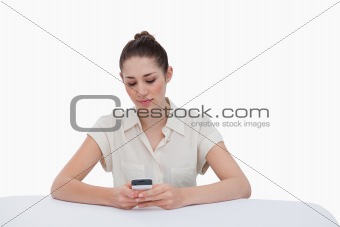 Businesswoman writing a text message