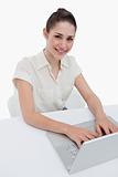 Portrait of a smiling businesswoman using a laptop