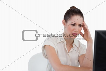 Sad businesswoman using a monitor