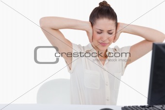 Exhausted businesswoman having a headache while using a computer