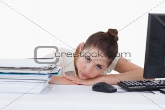 Sad secretary leaning on her desk