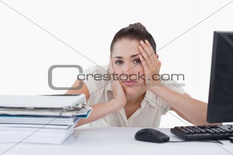 Tired businesswoman leaning on her desk