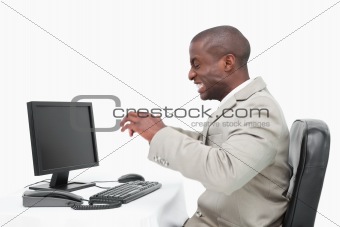Angry businessman using a monitor