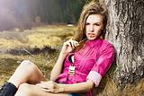 Fashion portrait of young beautiful woman in nature