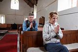 A man and a woman praying