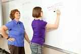 Stock Photo of Student and Teacher at Blackboard