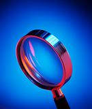 Magnifying glass on blue