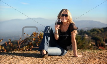 Blond woman with a glass of wine