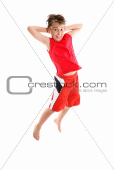 Boy jumping hands behind head