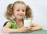 The girl drinks for breakfast milk, over white