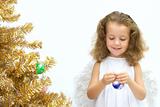 Angel decorating a christmas tree