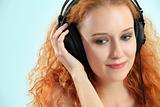 Beautiful young redhead with headphones