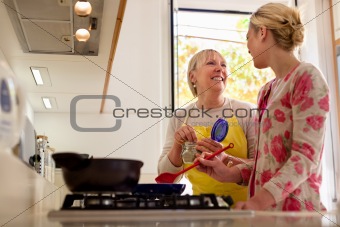 mom and daughter cooking in home kitchen