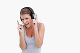 Cheerful woman dancing while listening to music