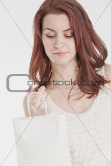 Young woman holding a white shopping bag