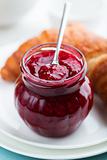 Jar of raspberry jam with spoon