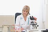 Middle age doctor woman working with microscope