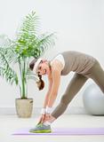 Smiling healthy woman making stretching exercises