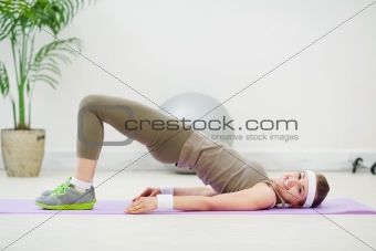 Happy fitness girl making gymnastics