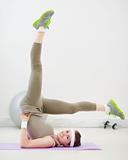 Healthy slim woman doing gymnastics exercises