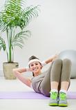 Happy fitness woman doing abdominal crunch