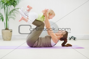 Healthy mother and baby making gymnastics