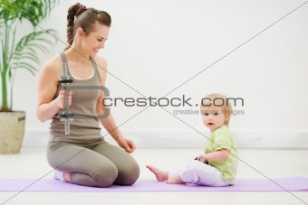 Healthy mother and baby spending time doing fitness