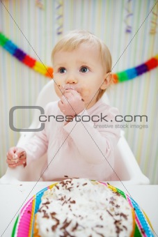 Eat smeared baby eating birthday cake