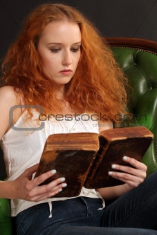 Beautiful redhead reading a bible