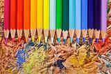 Multicolor pencils raibow on the shavings background