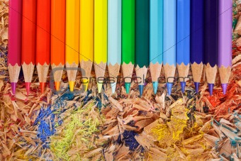 Multicolor pencils raibow on the shavings background