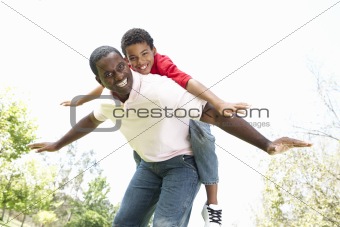 Portrait of Happy Father and Son In Park