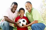 Grandfather With Son And Grandson In Park With Football
