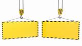 Two crane hooks with blank yellow plates
