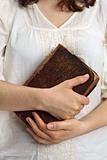 Hands holding old bible