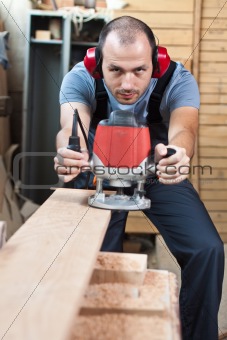 Worker with a router, vertical.