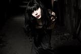 Closeup portrait of beautiful goth girl in dark tunnel
